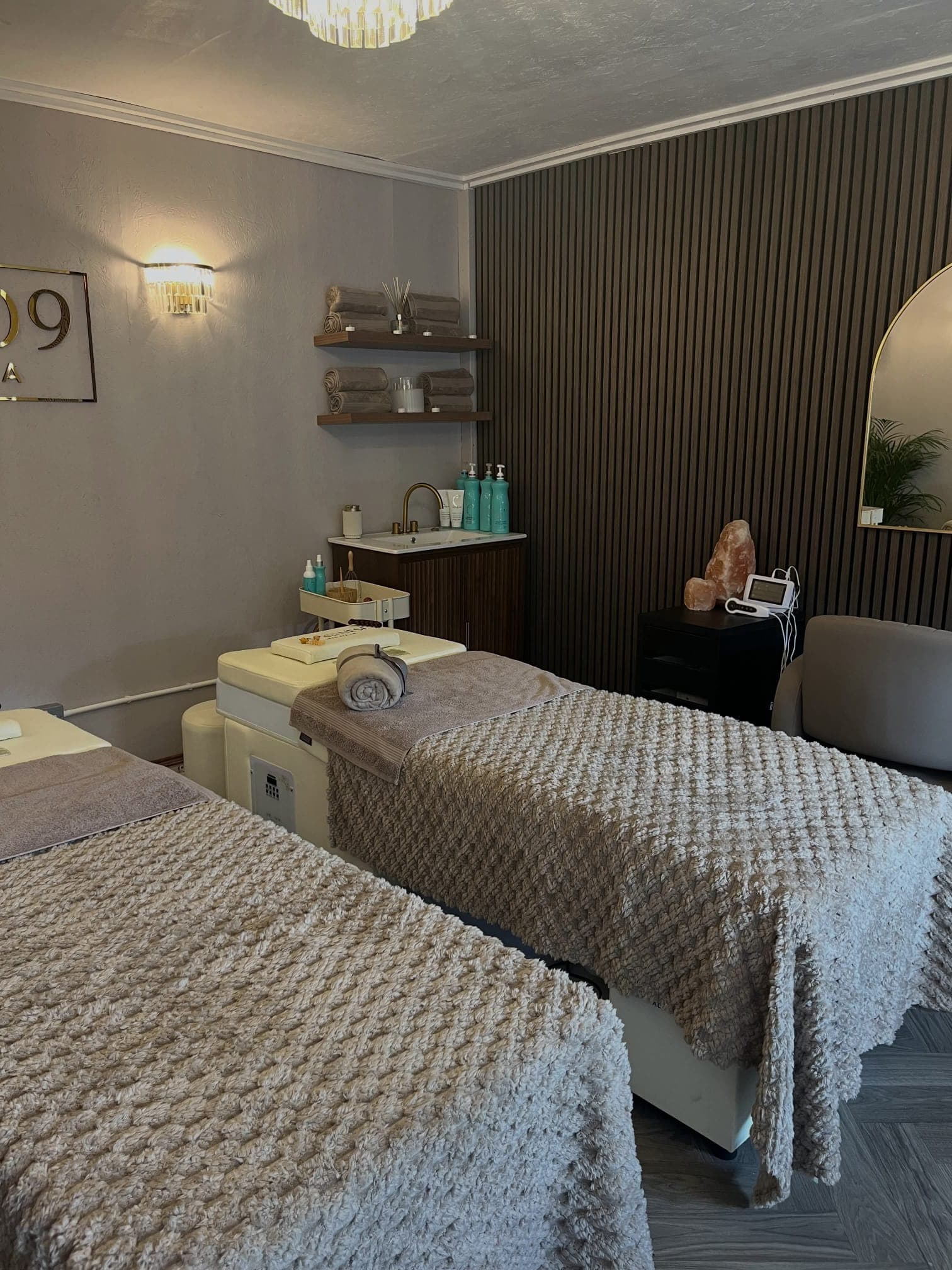 Cloud9 Head Spa treatment room details with vanity, products and wood accent wall